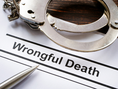 Close-up of a wrongful death document with handcuffs and pen, representing legal claims and compensation in Oregon wrongful death cases.