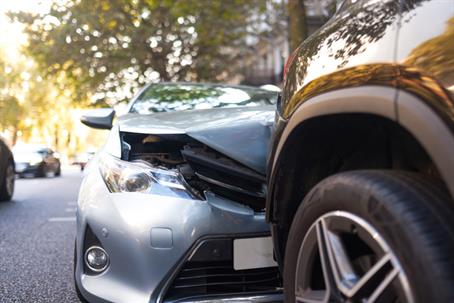 Close-up of a two-car crash showing front-end damage, illustrating fault in Oregon car accidents.